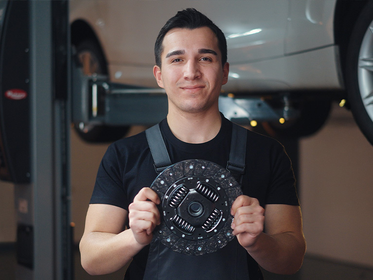 mechanic holding a clutch disc